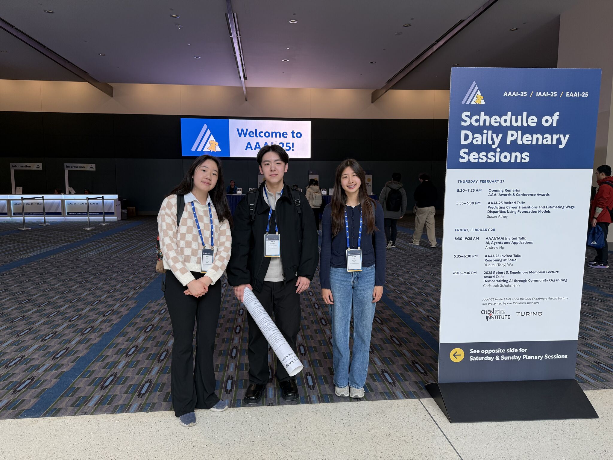 Rory Hu on the left, Tianyi Huang in the center, and Elsa Fan on the right at AAAI 2025.