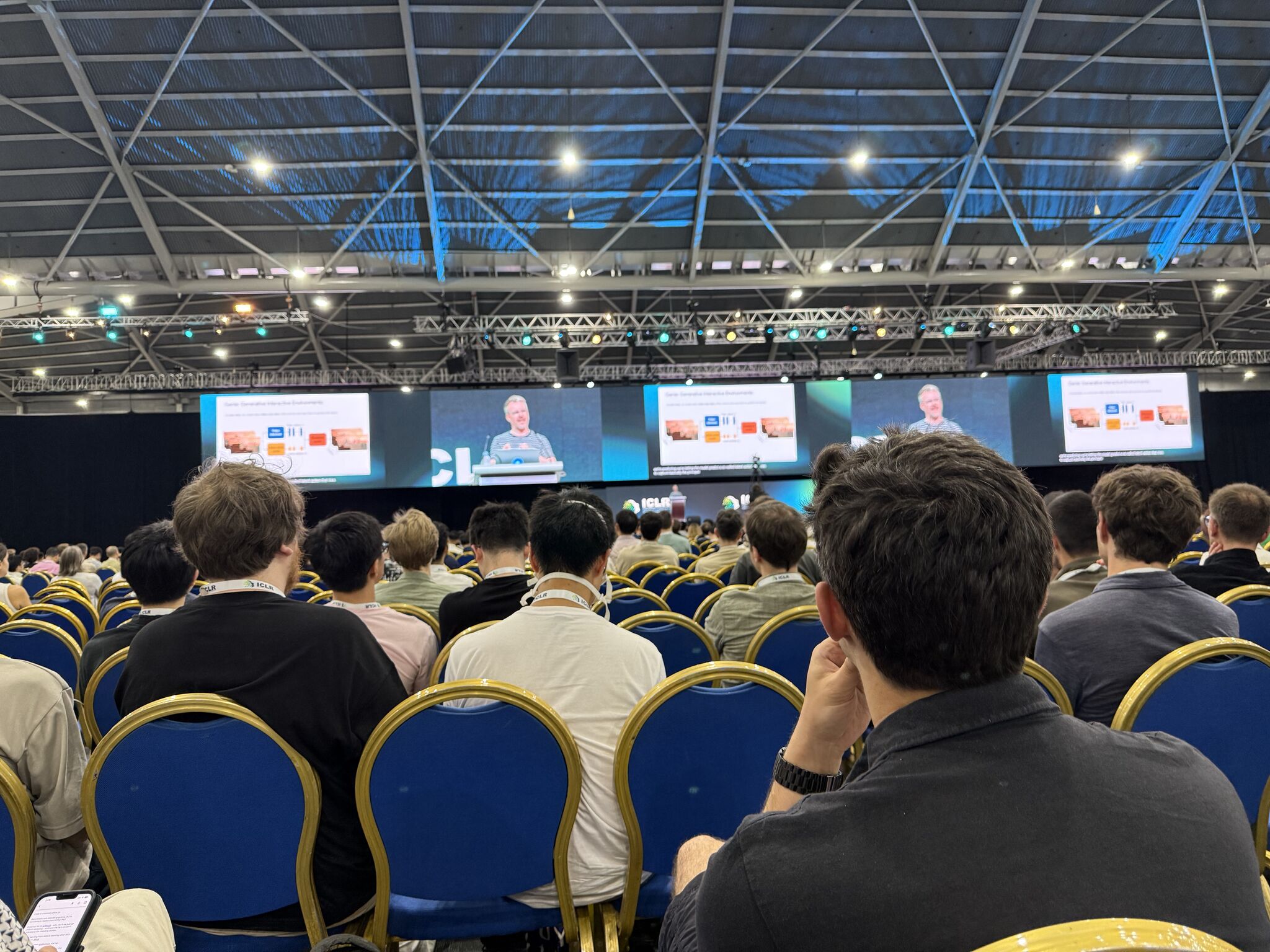 An audience watching Tim Rocktäschel’s invited talk at ICLR 2025.