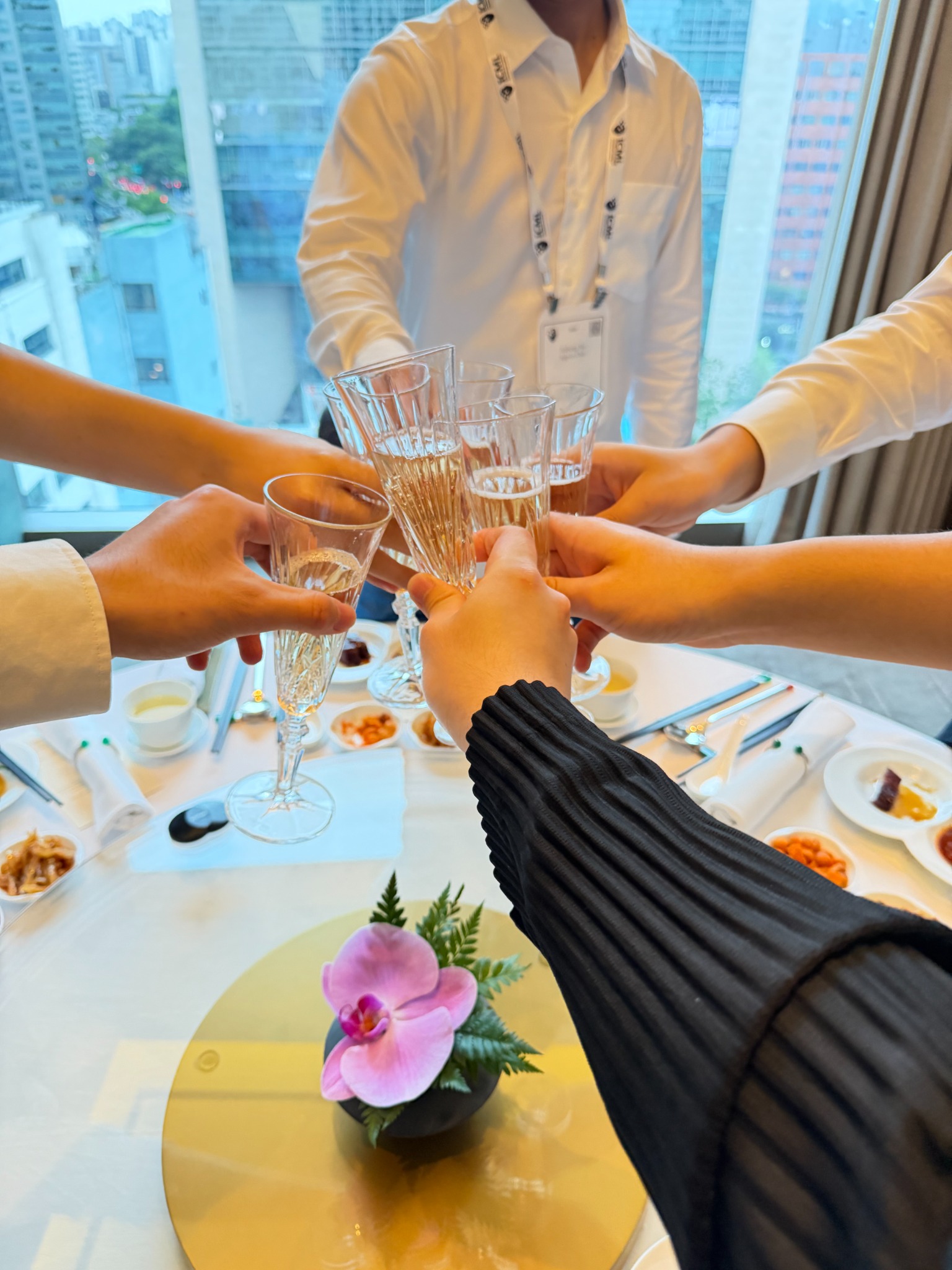 Team members raising their glasses together at ICML 2026.