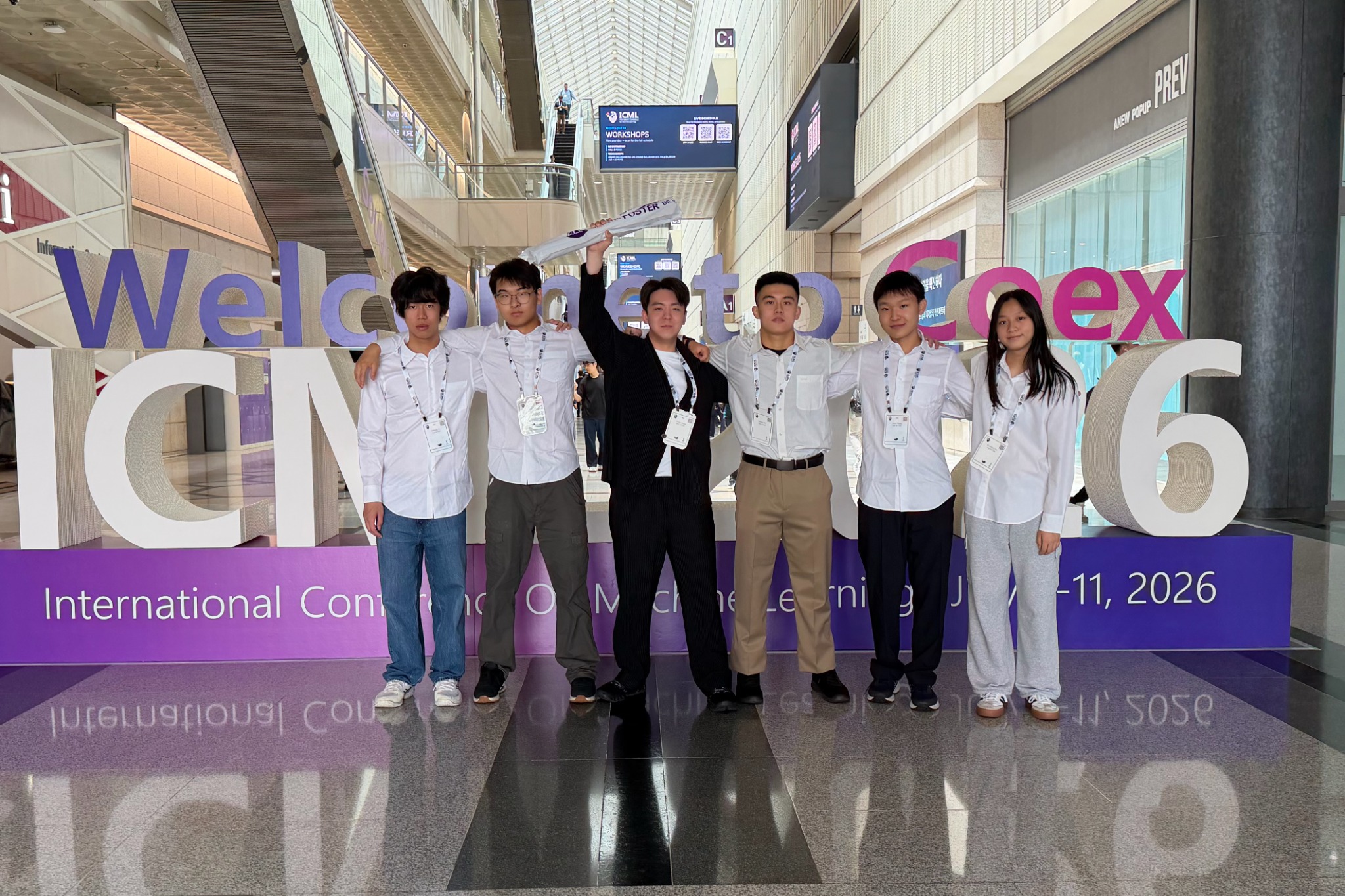 Six App-In Club team members together in front of the ICML 2026 sign.