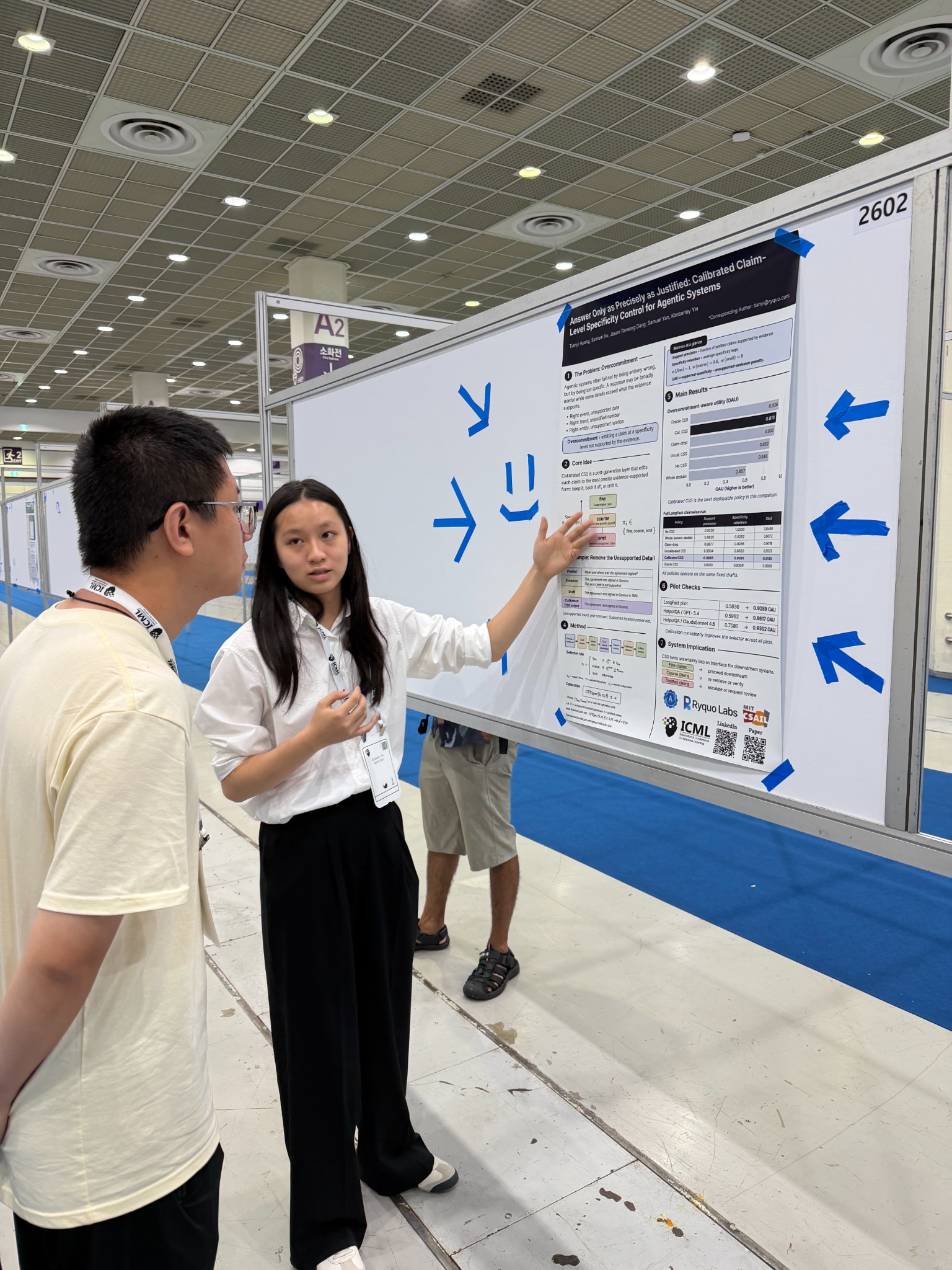 Kimberley Yin explaining her research poster to an attendee at ICML 2026.