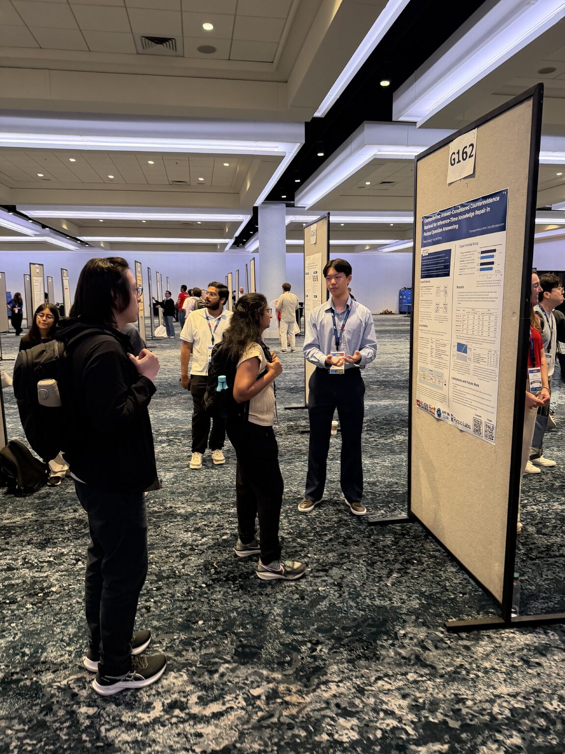 Kai Deng discussing his research poster with attendees at ACL 2026.